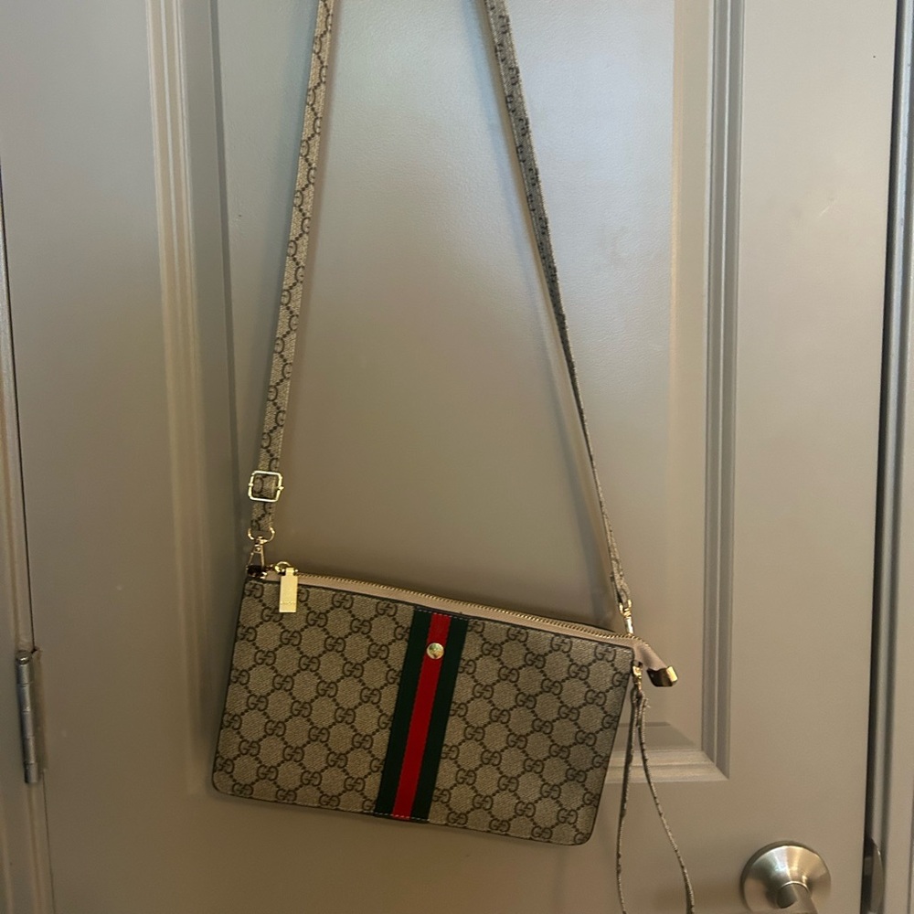 Crossbody or can be used as a wristlet. Used once.